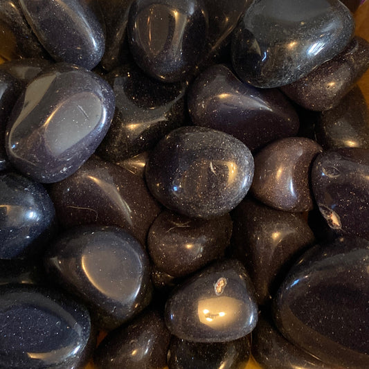 Polished Blue Goldstone tumble stones with deep blue tones and sparkling flecks resembling the night sky