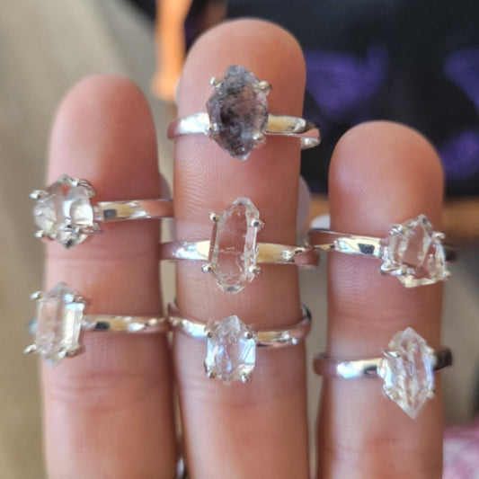 Collection of handcrafted Ring Herkimer Diamond with clear, sparkling stones on silver bands displayed on fingers