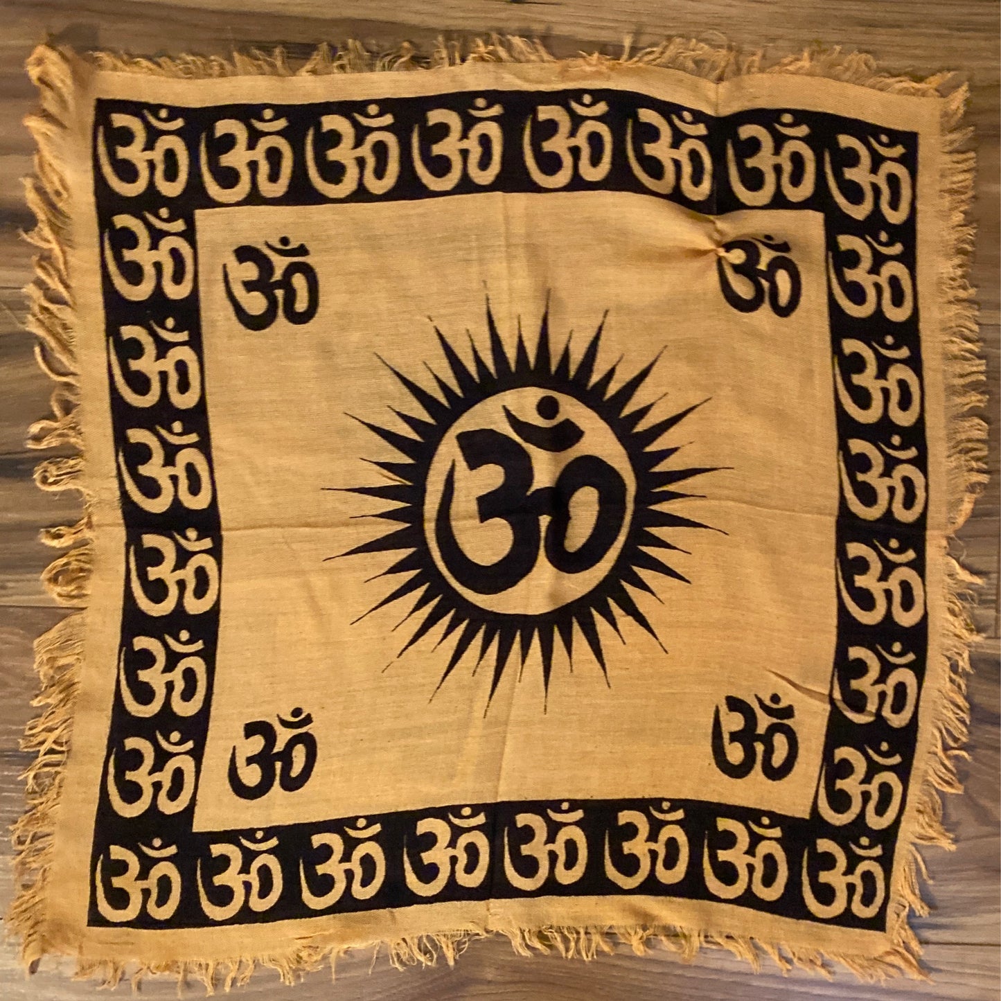 Om altar cloth with black Om symbols on beige fabric and fringed edges