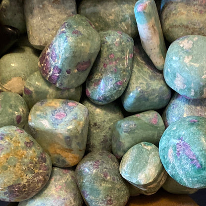 Tumbled Ruby Fuchsite stones with green base and ruby red spots clustered together