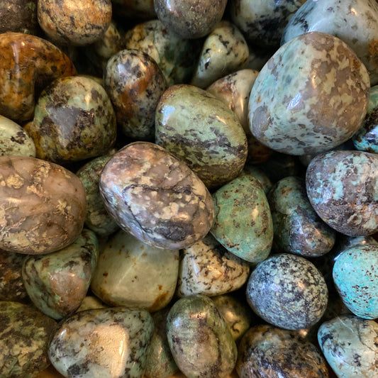 Polished African turquoise tumble stones with unique mineral patterns promoting balance and vitality
