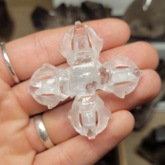Clear Dorje Quartz held in hand with intricate carved details