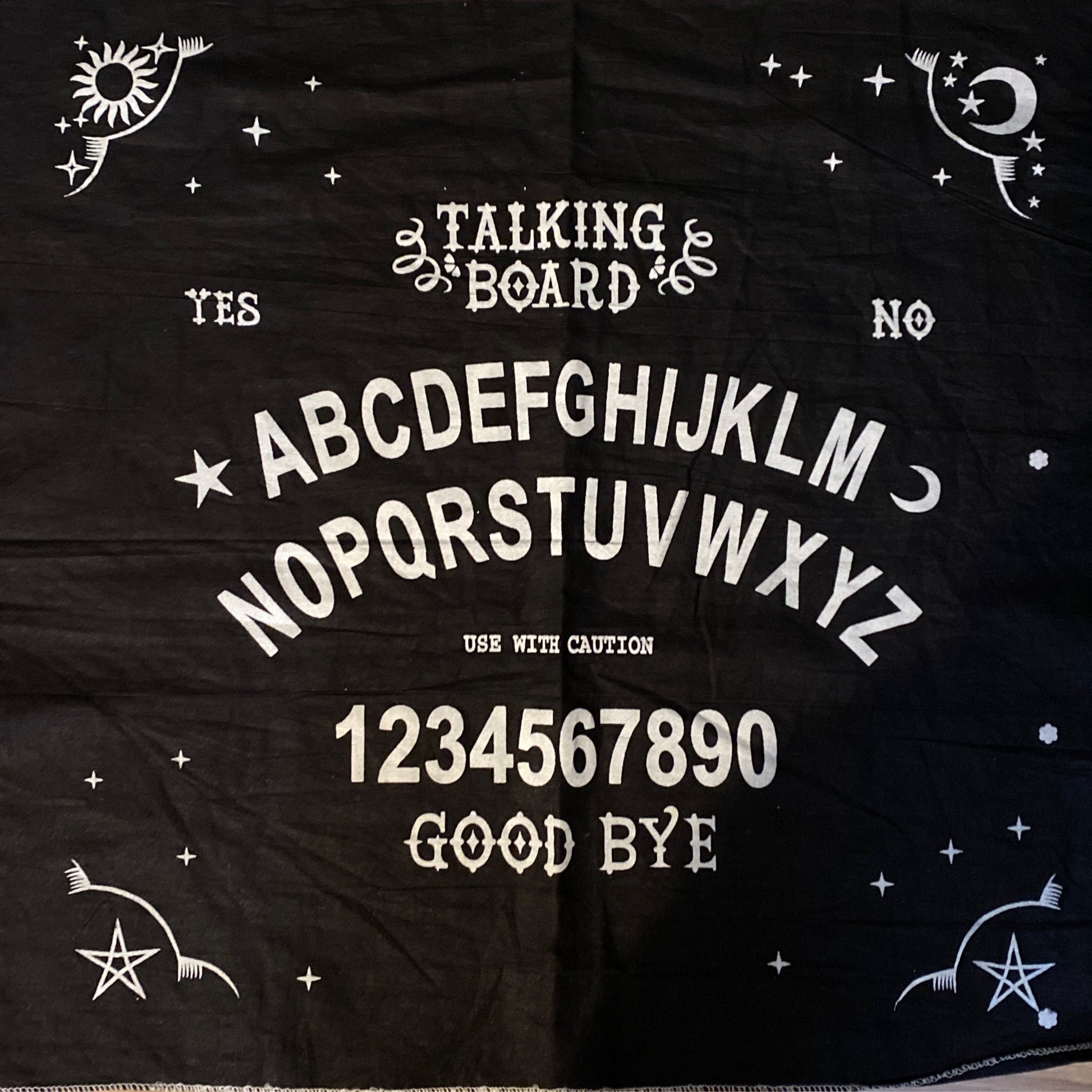 Black talking board altar cloth featuring alphabet, numbers, yes/no options, and mystical symbols