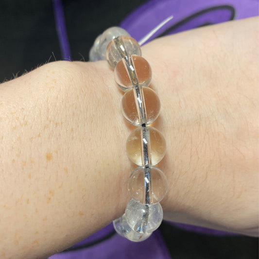 Adjustable clear quartz bracelet with round beads on wrist