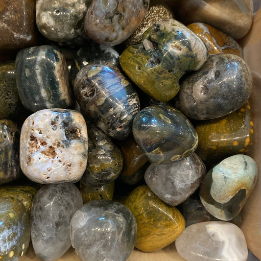 Collection of polished Ocean Jasper tumble stones with vibrant colors and intricate patterns.