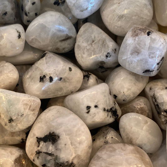Smooth white and gray moonstone tumbles with black inclusions enhancing intuition and harmony