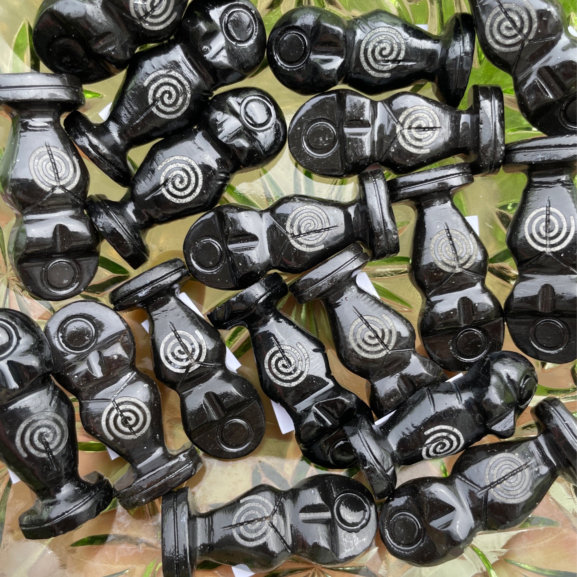 Black onyx goddess statues with spiral designs symbolizing strength and femininity